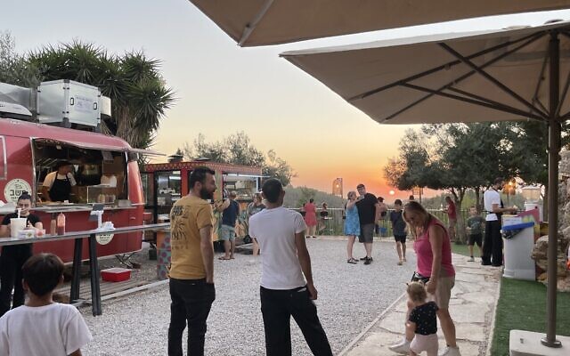 Waiting for dinner on a hot August night at Mashav Food Trucks, off Route 1 outside Jerusalem (Jessica Steinberg/Times of Israel)