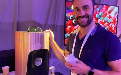 Food technologist Yaron Renasia displays the Solato ice cream machine at the PLANETech World 2022 in Tel Aviv, September 21, 2022. (Shoshanna Solomon)