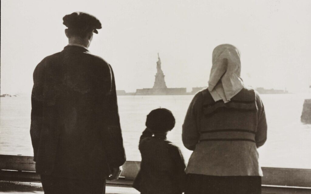 An immigrant family looking at the Statue of Liberty from Ellis Island, circa 1930. (Library of Congress)