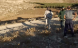 Masked settlers approach a Palestinian man on private Palestinian land close to the Havat Ma'on illegal settlement outpost in the south Hebron Hills, in an incident on September 12, 2022. (Screenshot)