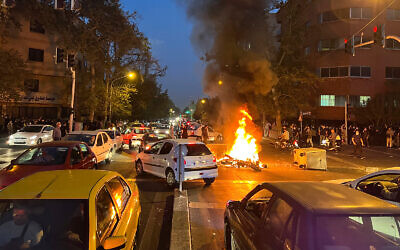 A police motorcycle burns during a protest, in downtown Tehran, Iran, September 19, 2022. (AP Photo, File)