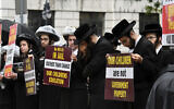 Members of US Haredi Jewish communities hold a protest before a Board of Regents meeting to vote on new requirements that private schools teach English, math science and history to high school students outside the New York State Education Department Building in Albany, New York, September 12, 2022. (Will Waldron/The Albany Times Union via AP)