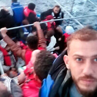 Jihad Michlawi, right, takes a selfie on board an overcrowded migrant boat carrying about 150 Lebanese, Syrians, and Palestinians in the Mediterranean Sea, Lebanon, September 21, 2022. (Courtesy of Jihad Michlawi via AP)