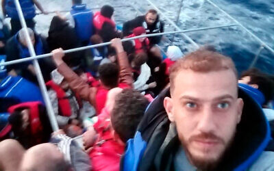 Jihad Michlawi, right, takes a selfie on board an overcrowded migrant boat carrying about 150 Lebanese, Syrians, and Palestinians in the Mediterranean Sea, Lebanon, September 21, 2022. (Courtesy of Jihad Michlawi via AP)