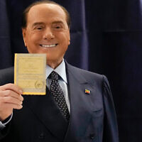 Silvio Berlusconi, leader of the center-right party Forza Italia shows a ballot before casting his vote at a polling station in Milan, Italy, September 25, 2022, in Milan, Italy. (AP Photo/Antonio Calanni)