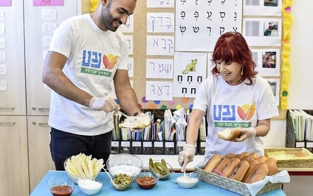 Making sandwiches for kids in need at Nevet, which is currently launching a campaign for the 2022-2023 school year. (Courtesy: Nevet)