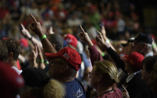Audience members raise their right arms while former US president Donald Trump speaks at a in Youngstown, Ohio, September 17, 2022. (Jeff Swensen/Getty Images/AFP)