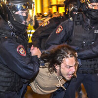 Police officers detain a man at a protest against military mobilization, in Moscow, on September 21, 2022. (Alexander Nemenov/AFP)
