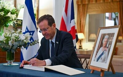 President Isaac Herzog signs a condolence book for Queen Elizabeth II at the British ambassador's residence in Tel Aviv, September 10, 2022. (Kobi Gideon/GPO)