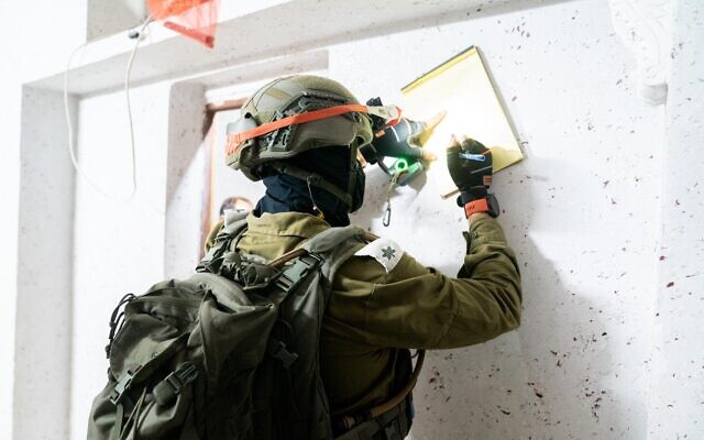 Israeli troops map out the home of a Palestinian gunmen who killed an officer along the West Bank security barrier, in the village of Kafr Dan, September 15, 2022. (Israel Defense Forces)