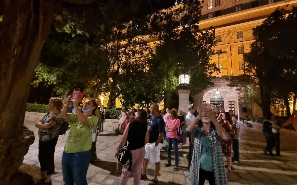 Guests alight momentarily from the night bus tour in front of the King David Hotel and across from the YMCA, for a photo op. (Shmuel Bar-Am)