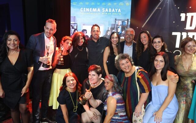 The cast and crew of 'Cinema Sabaya' pose with their Ophir Awards after winning Best Picture and other prizes, September 18, 2022. (courtesy)