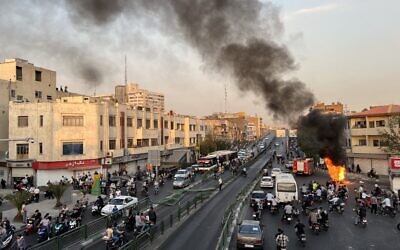 A motorcycle on fire in Iran's capital Tehran, on October 8, 2022. (A picture obtained by AFP outside Iran)