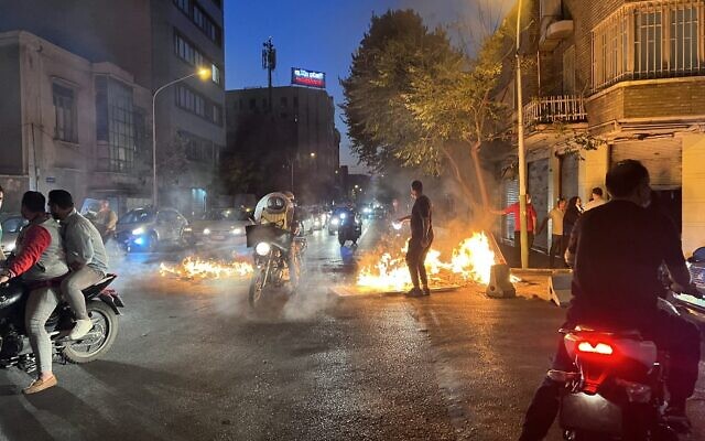 Items lit on fire in the capital Tehran, on October 8, 2022. (A picture obtained by AFP outside Iran)