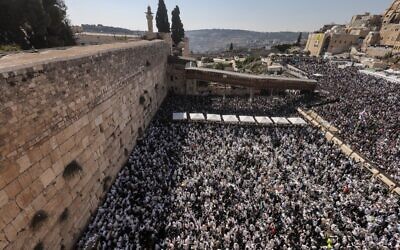 Jews gather at the Western Wall in the Old City of Jerusalem on October 12, 2022, for the annual priestly blessing, during the holiday of Sukkot. (Menahem KAHANA / AFP)