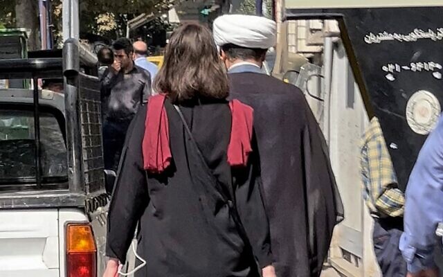 A picture obtained by AFP outside Iran shows a woman walking without a head scarf in the heart of the Iranian capital Tehran, on October 11, 2022. (AFP)