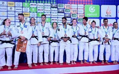 Bronze medallists Team Israel celebrates during the medal ceremony for the mixed teams event of the 2022 World Judo Championships at the Humo Arena in Tashkent on October 13, 2022. (Kirill Kudryavtsev/AFP)