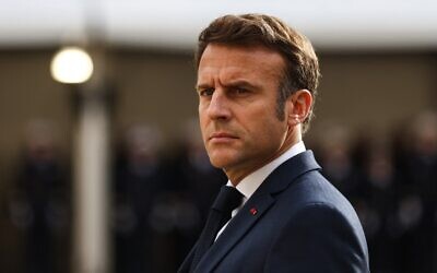 French President Emmanuel Macron looks on as he attends a tribute ceremony to veterans of the Algerian War, at the Hotel National des Invalides, in Paris on October 18, 2022. (Mohammed Badra/Pool/AFP)