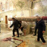 Workers clean up following an deadly armed attack at the Shah Cheragh mausoleum in the Iranian city of Shiraz on October 26, 2022. (Mohammadreza Dehdari/ISNA News Agency/AFP)