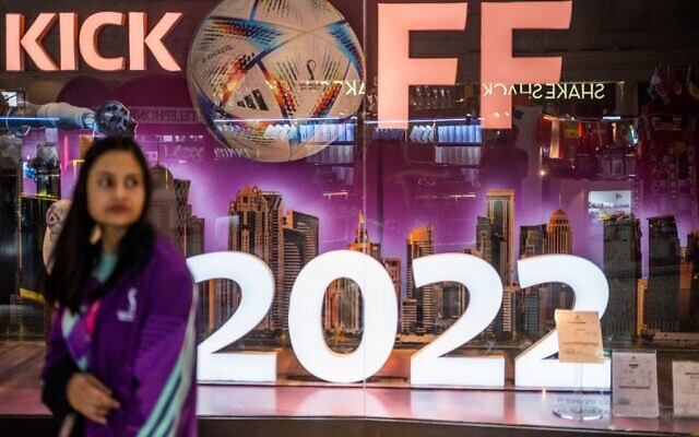 A woman walks past a store in a mall in Doha on October 29, 2022, ahead of the Qatar 2022 FIFA World Cup football tournament. (Photo by Jewel SAMAD / AFP)