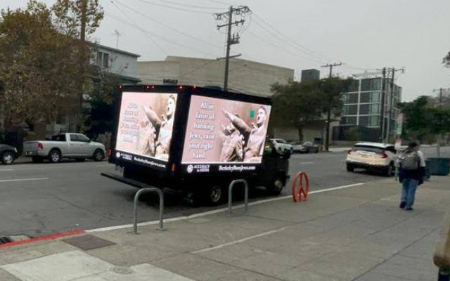 A truck emblazoned with an image of Adolf Hitler and the phrase 'All in favor of banning Jews, raise your right hand,' drove through Berkeley, California, October 2022, in response to a controversy involving several UC Berkeley Law student groups resolving to bar 'Zionist' speakers. (Courtesy of Accuracy in Media)