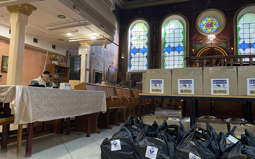 Food parcels, ready to be delivered to Jews in Lviv, are piled up waiting until the end of morning prayers before they can be ferried out to those waiting outside. (Jacob Judah/ JTA)