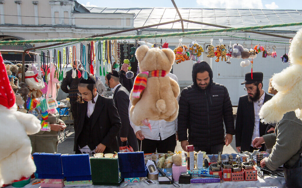 Tourists look for souvenirs at a bazaar in Uman. (David Saveliev/ JTA)