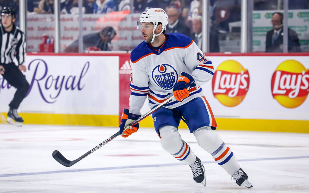 Jason Demers, #44 of the Edmonton Oilers, keeps an eye on the play during first period action against the Winnipeg Jets in pre-season action at the Canada Life Centre on October 1, 2022, in Winnipeg, Manitoba, Canada. (Photo by Darcy Finley/NHLI via Getty Images/ via JTA)