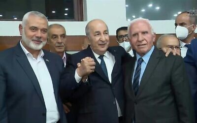 Algerian President Abdelmadjid Tebboune (C) poses for photographs with Hamas chief Ismail Haniyeh (L) and Azzam al-Ahmad, a Fatah Central Committee member, in Algiers, October 12, 2022. (Algerian Presidency via AFP)