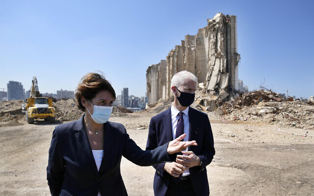 French Foreign Trade Minister Franck Riester, right and the French Ambassador to Lebanon Anne Grillo, visit Beirut's port, devastated in a massive deadly explosion in August last year, in Beirut, Lebanon, Tuesday, July 13, 2021.  (AP Photo/Hassan Ammar)
