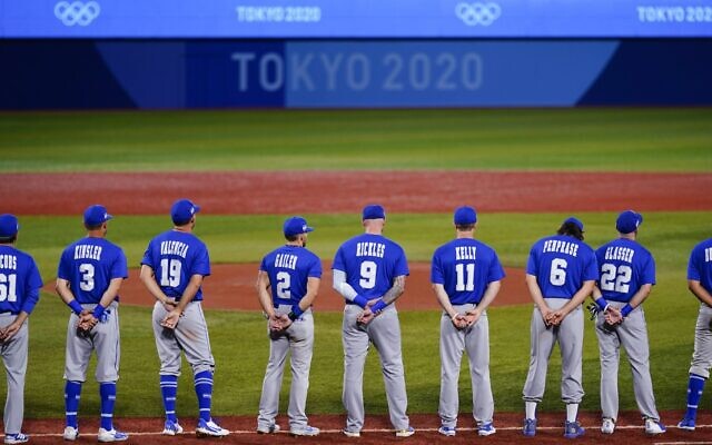 Members of Team Israel stand for their national anthem ahead of a baseball game against the Dominican Republic at the 2020 Summer Olympics, August 3, 2021, in Yokohama, Japan. (AP Photo/Matt Slocum)