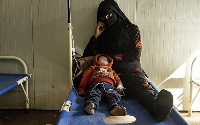 A mother sits with her child who was diagnosed with cholera in a hospital in Deir el-Zour, Syria, Thursday, September 29, 2022. (AP Photo/Baderkhan Ahmad)