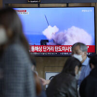 A TV screen showing a news program reporting about North Korea's missile launch with file footage, is seen at the Seoul Railway Station in Seoul, South Korea, Saturday, Oct. 1, 2022. (AP Photo/Lee Jin-man)