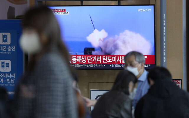 A TV screen showing a news program reporting about North Korea's missile launch with file footage, is seen at the Seoul Railway Station in Seoul, South Korea, Saturday, Oct. 1, 2022. (AP Photo/Lee Jin-man)