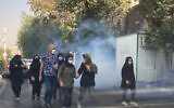 In this Oct. 1, 2022, photo taken by an individual not employed by the Associated Press and obtained by the AP outside Iran, tear gas is fired by security to disperse protesters in front of the Tehran University, Iran. (AP Photo)