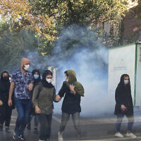 In this Oct. 1, 2022, photo taken by an individual not employed by the Associated Press and obtained by the AP outside Iran, tear gas is fired by security to disperse protesters in front of the Tehran University, Iran. (AP Photo)