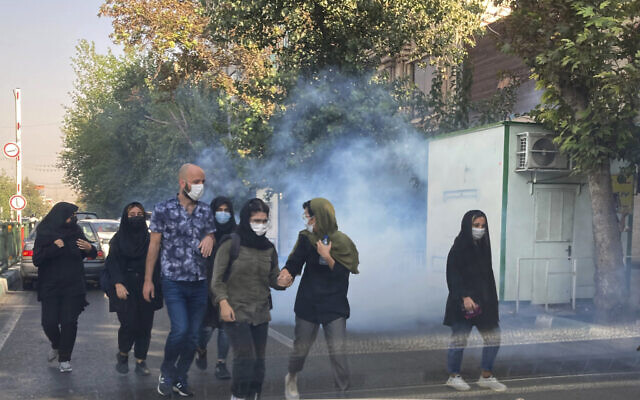 In this October 1, 2022, photo taken by an individual not employed by the Associated Press and obtained by the AP outside Iran, tear gas is fired by security to disperse protesters in front of the Tehran University, Iran. (AP Photo)