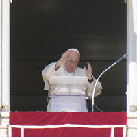 Pope Francis waves during the Angelus noon prayer from the window of his studio overlooking St. Peter's Square, at the Vatican, October 2, 2022. (AP Photo/Alessandra Tarantino)