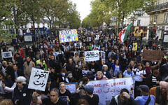 Protesters march to show support for Iranian protesters standing up to their leadership over the death of a young woman in police custody, Sunday, Oct. 2, 2022 in Paris. (AP/Aurelien Morissard)