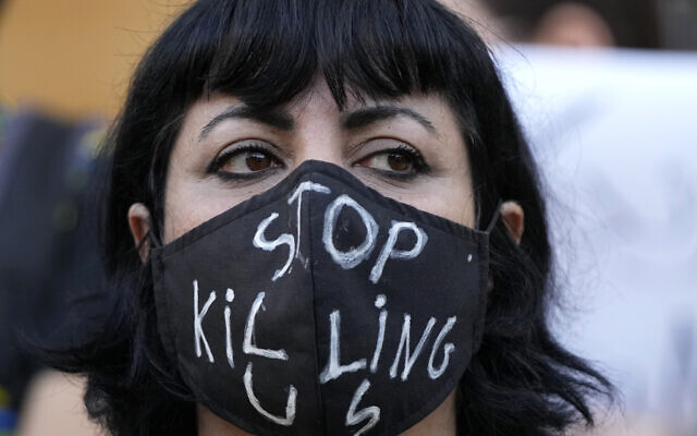 An activist wears a message on her protective face mask "Stop Killing Us" during a protest against the death of Iranian Mahsa Amini in Iran, in Beirut, Lebanon, Sunday, Oct. 2, 2022.(AP/Hassan Ammar)