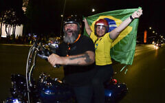 Supporters of Brazilian President Jair Bolsonaro ride a motorcycle after the general election polls closed in Brasilia, Brazil, Sunday, Oct. 2, 2022. (AP/Ton Molina)