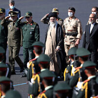 In this picture released by the official website of the office of the Iranian supreme leader, Supreme Leader Ayatollah Ali Khamenei, center, reviews a group of armed forces cadets during their graduation ceremony accompanied by commanders of the armed forces, at the police academy in Tehran, Iran, October 3, 2022. (Office of the Iranian Supreme Leader via AP)