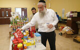 Rabbi Yitzchok Minkowicz supervises the pantry inside the Chabad Lubavitch of Southwest Florida, Monday, Oct. 3, 2022, in Fort Myers, Fla. (AP Photo/Marta Lavandier)