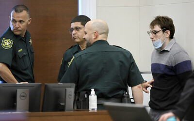 Marjory Stoneman Douglas High School shooter Nikolas Cruz leans against a wall in the courtroom at the Broward County Courthouse in Fort Lauderdale, Florida on October 13, 2022. (Mike Stocker/South Florida Sun Sentinel via AP, Pool)