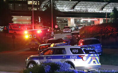 An EMS vehicle believed to be carrying the suspect in a multiple shooting arrives at WakeMed emergency room with a heavy police escort in Raleigh, North Carolina, Oct. 13, 2022. (AP Photo/Chris Seward)