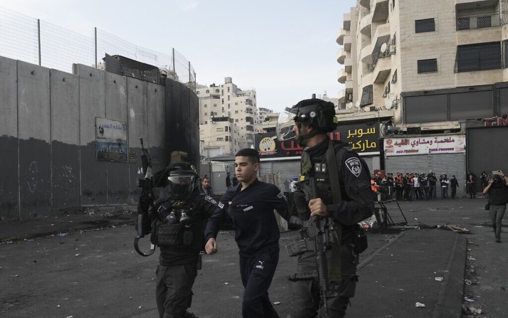 Israeli police arrest a Palestinian during clashes in Shuafat refugee camp in East Jerusalem, Wednesday, Oct.12. 2022 (AP Photo/Mahmoud Illean, File)