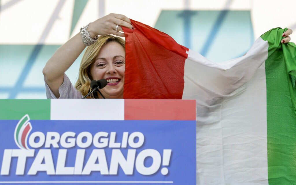 Giorgia Meloni holds an Italian flag as she addresses a rally in Rome, October 19, 2019. (AP Photo/Andrew Medichini)