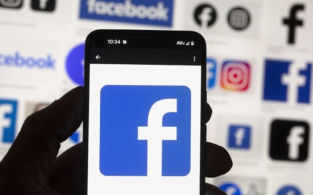 FILE - The Facebook logo is seen on a mobile phone, Oct. 14, 2022, in Boston. (AP Photo/Michael Dwyer, File)