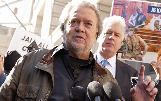 Steve Bannon, center, a longtime ally of former President Donald Trump and convicted of contempt of Congress, accompanied by his attorney Evan Corcoran, right, speaks to the media as he leaves the federal courthouse on Friday, October 21, 2022, in Washington DC. (AP/Jose Luis Magana)