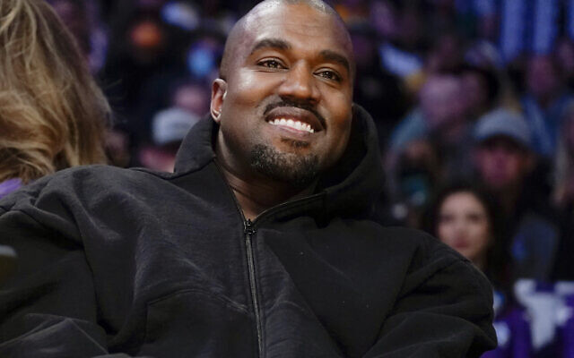 FILE - Kanye West watches the first half of an NBA basketball game between the Washington Wizards and the Los Angeles Lakers in Los Angeles, on March 11, 2022. (AP Photo/Ashley Landis, File)